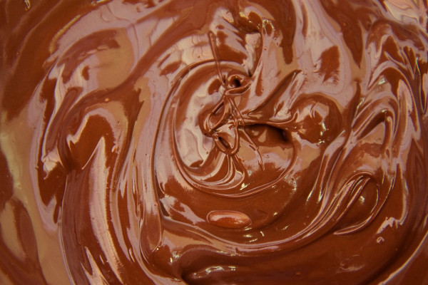 Swirled melted milk chocolate reflecting light